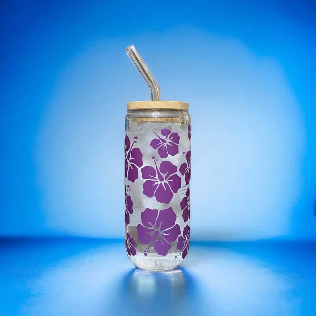 Glass cup with bamboo lid showing multi-size hibiscus flowers.