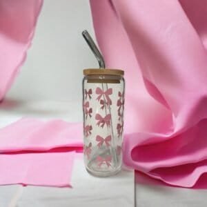 Glass cup with bamboo lid showing coquette pink bows.